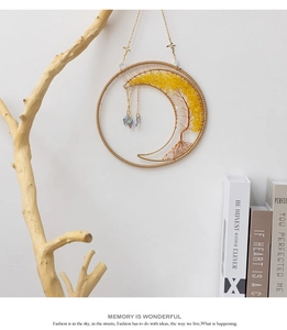 Detail of tree of life wall hanging with yellow crystal stones and moon frame