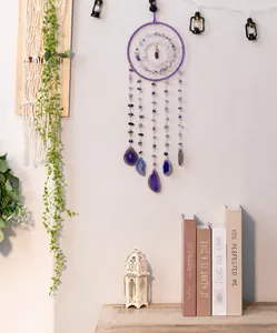 Purple dream catcher with amethyst gravel and agate slices hanging as wall decor
