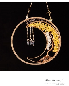 Detail of moon and tree of life hanging decor with crystals and gold wire work
