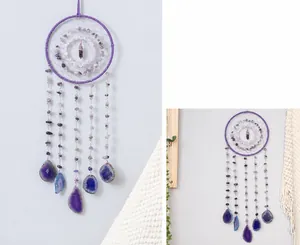 Detail of purple amethyst dream catcher with hanging natural agate slices decor