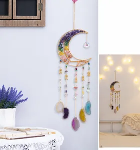 Moon dreamcatcher wall hanging with crystal tree of life and agate stone slices in bedroom
