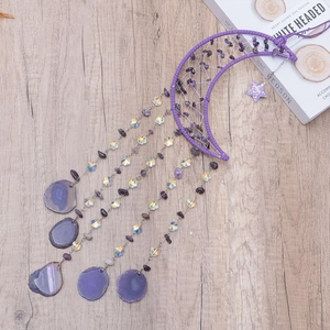 Amethyst crescent moon dream catcher wind chime with agate slices on wooden background