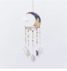 Detailed close-up of a moon-shaped golden dreamcatcher with chakra healing crystals