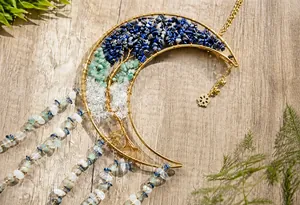 Detail of moon dreamcatcher with tree of life wire wrap and natural crystal stones