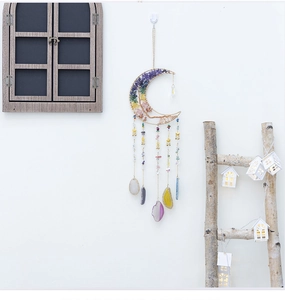 Moon-shaped dream catcher with colorful chakra stones and hanging agate slices