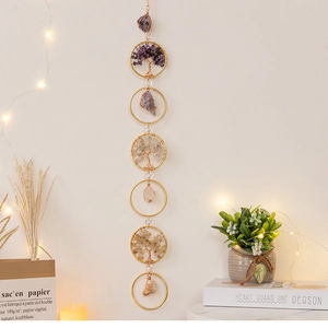 Detail of 7 chakra natural crystal tree of life suncatcher with golden metal rings