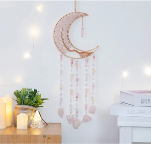 Detail of moon-shaped pink crystal tree of life wall hanging with natural stone tassels