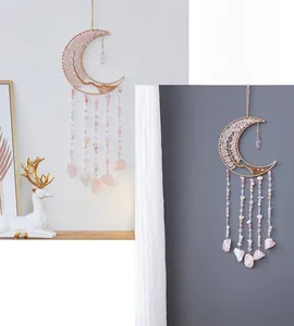 Macro detail of moon dream catcher with pink crystal tree of life and beaded stone tassels