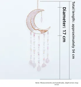 Detailed view of handmade pink crystal moon Tree of Life dreamcatcher with hanging gems