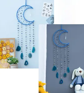 Detail of moon-shaped dream catcher with blue stone beads and natural agate slices