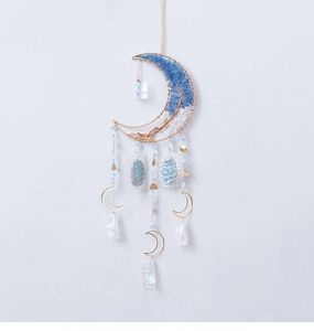 Detail of bohemian gold crescent moon hanging ornament with blue crystal tree stones