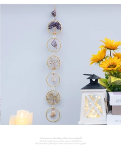 Detail of multi-layered Tree of Life wall hanging with natural crystals and golden rings