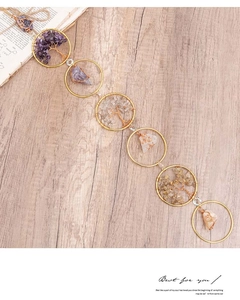 Detail of bohemian tree of life crystal suncatcher with natural gemstones and gold rings