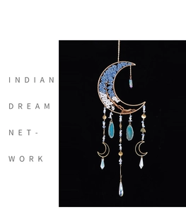 Detail of moon-shaped dreamcatcher with agate slices and tree of life crystal design