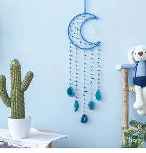 Detailed close-up of blue moon dream catcher with natural agate slices and beads