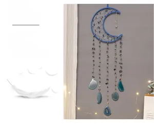 Detail of blue crescent moon dreamcatcher with natural agate slices and crystals