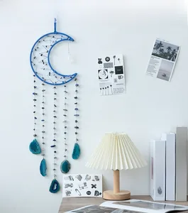 Detailed view of handmade moon dreamcatcher with blue agate slices and beads decor