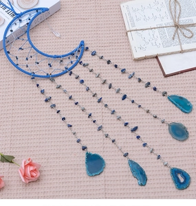 Detail of blue moon dream catcher with lapis lazuli stones and agate slice pendants