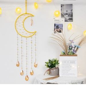 Detail of yellow moon dreamcatcher with crystal beads and lemon LED string lights