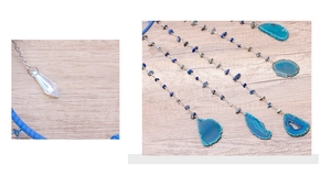 Detailed view of blue agate slices, lapis beads, and crystal point on silver chain