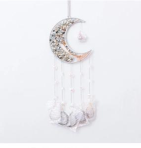 Detail of metal crescent moon wall hanging with crystal tree of life and beaded tassels