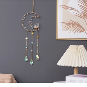 Moon-shaped crystal suncatcher with golden metal frame and iridescent teardrop pendants