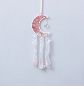 Detail of pink crystal life tree moon dreamcatcher with feathers and crystal ball pendant
