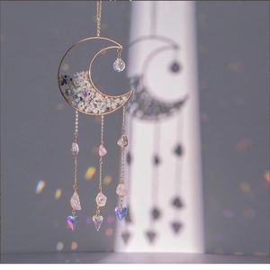 Detail of moon-shaped crystal suncatcher with amethyst stones and prism pendant