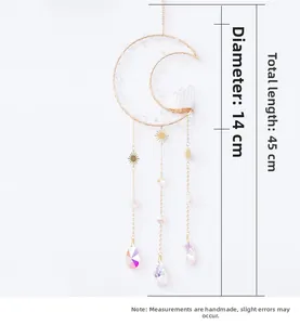Detail view of moon-shaped crystal suncatcher with gold frame and raw stone cluster