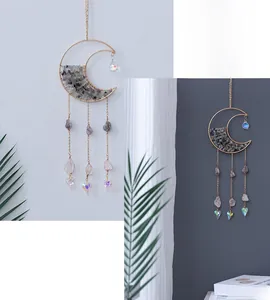 Detail of moon-shaped crystal suncatcher with natural purple and green stones
