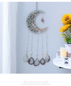 Detail of moon-shaped wall hanging featuring Tree of Life wire wrap and natural stones