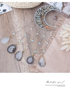 Detail of moon dreamcatcher with blue stones, Tree of Life, and agate slice charms
