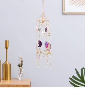 Detail of crystal suncatcher with agate slices and golden moon and star charms