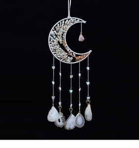 Detailed view of silver crescent moon wall decor with stone Tree of Life and agate slices