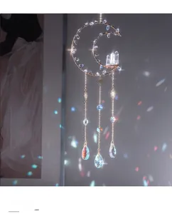 Close-up of golden moon crystal suncatcher with colorful light refraction details