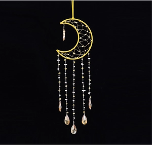 Detail of yellow crescent moon dreamcatcher with crystal beads and teardrop pendants