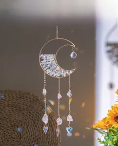 Detail of golden crescent moon suncatcher with purple crystal stones and heart prisms
