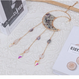 Bohemian gold crescent moon suncatcher with purple fluorite and crystal prisms on lace