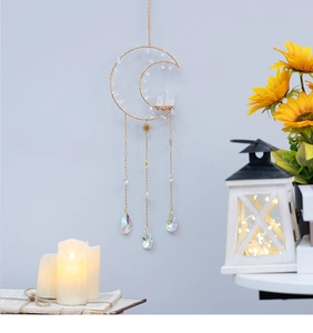Detail of golden moon suncatcher with raw crystals and teardrop prisms for home decor