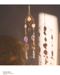 Detail of crystal suncatcher with purple agate slices and golden geometric frame