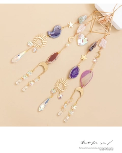 Detail of bohemian suncatcher with natural agate slices and golden moon star charms