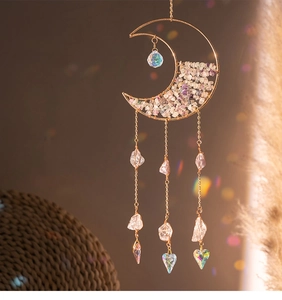 Detail of golden crescent moon crystal suncatcher with rainbow heart prisms and amethyst
