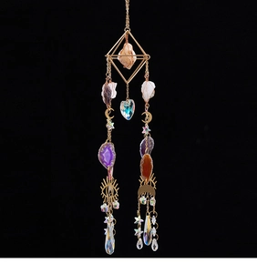 Detail of suncatcher with natural agate slices, crystal beads, and celestial moon star motifs