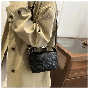 Detailed close-up of heart-shaped quilted pattern on a black luxury PU leather bucket bag