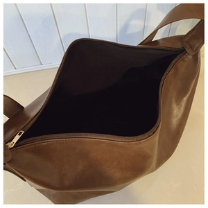 Top view of large brown tote bag showing spacious interior and silver zipper closure