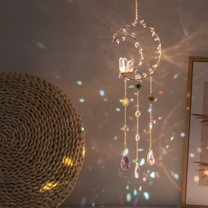 Golden moon sun catcher with natural crystal cluster and prisms creating rainbow light