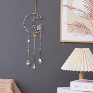 Moon shaped crystal suncatcher with gold metal frame and hanging prisms for garden decor