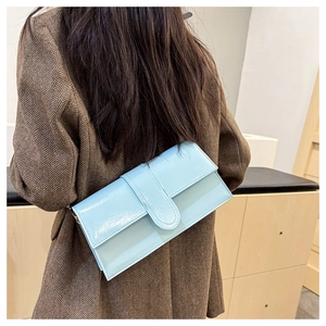 Light blue patent leather baguette bag styled with a brown vintage plaid blazer