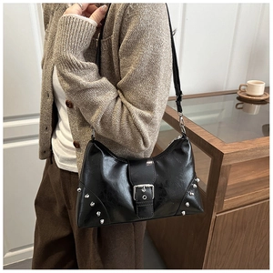 Detail view of black rivet tote bag with silver studs and premium leather texture