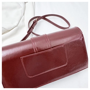 Detailed back view of deep red leather bag showing the rear pocket and fine stitching